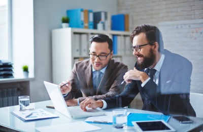two businessmen looking at laptop