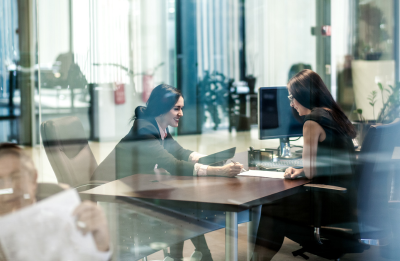 two women talking at a table
