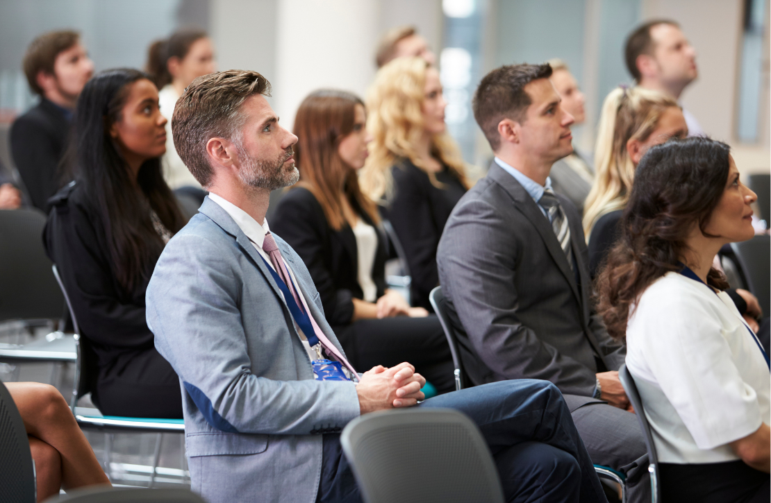 group of people listening to a lecture