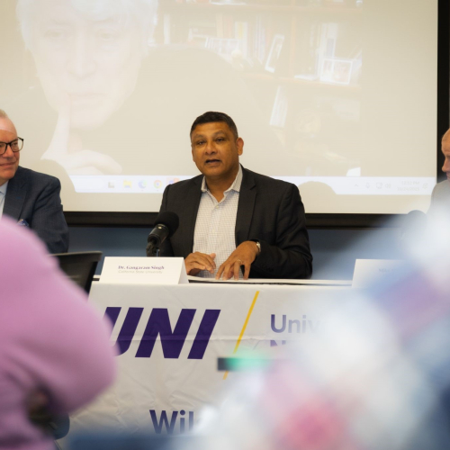 man speaking at a conference table