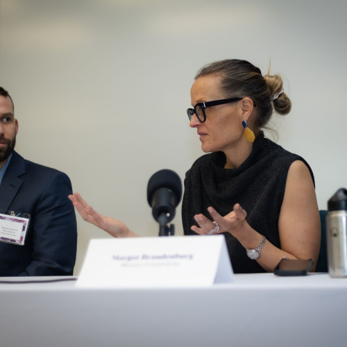 man and woman speaking at conference table