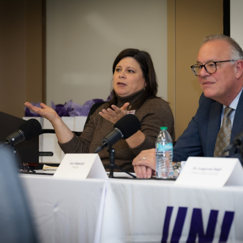 man and woman sitting at conference table